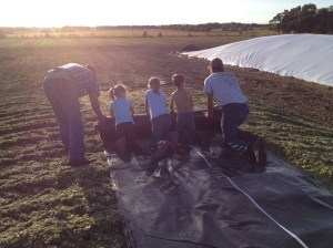 All hands are needed to cover a pile big or small